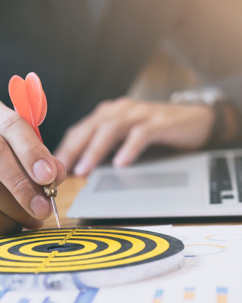 Businessman holding red dart push on target. Business strategy planning success target goals. Business development concept